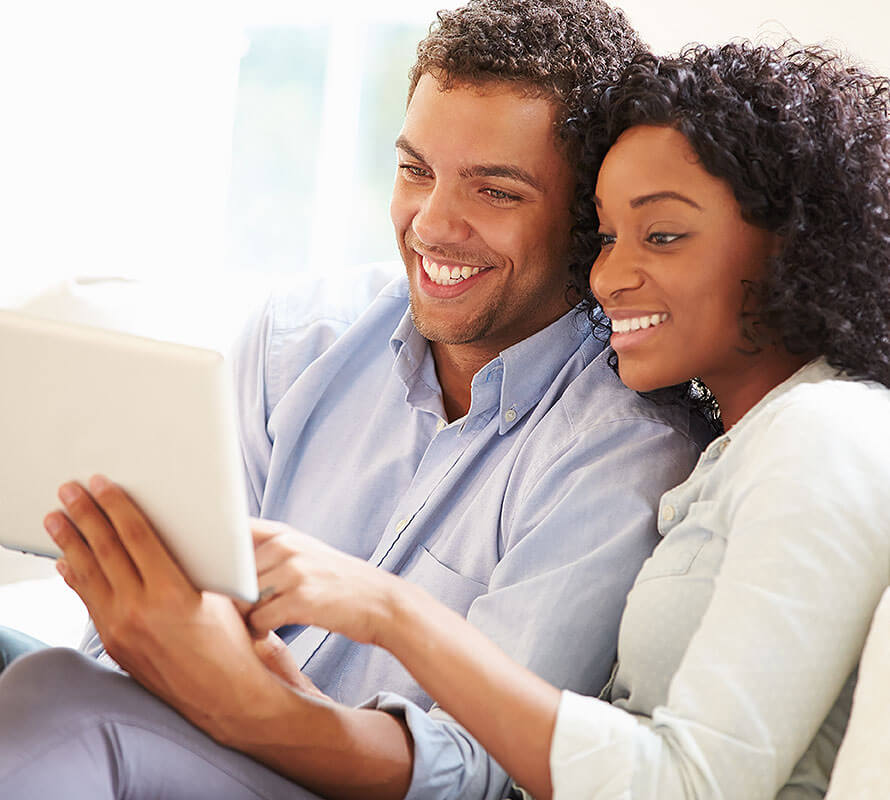 Woman and Man Looking at a Tablet Computer